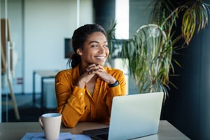 Portrait of Dreamy African American Businesswoman Sitting at Des